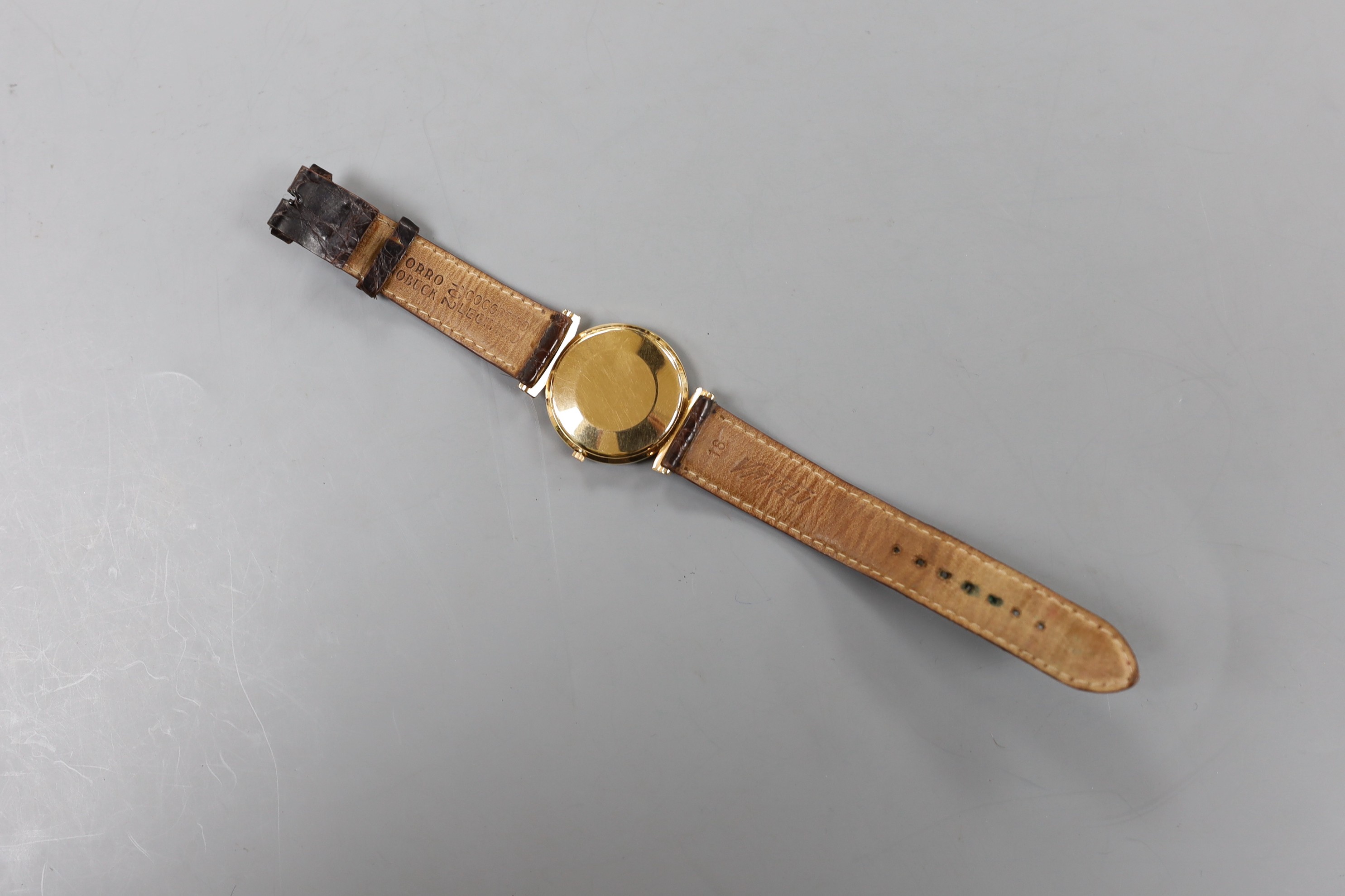 A gentleman's yellow metal Eterna-Matic wrist watch, with date aperture, on associated leather strap (lacking buckle), with baton numerals.